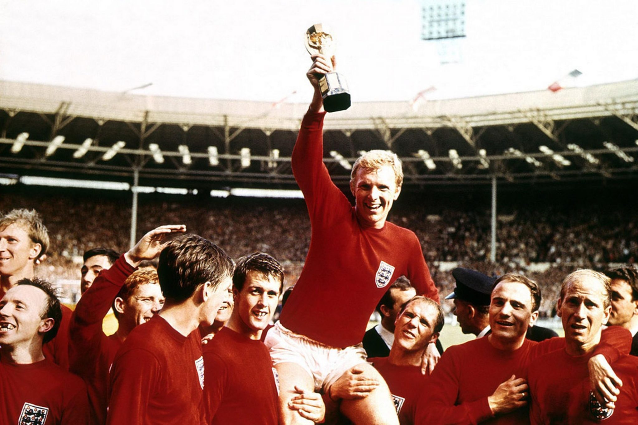 Bobby Moore holds aloft the Jules Rimet trophy as he sits on the shoulders of his teammates L R Jack Charlton Nobby Stiles Gordon Banks 838429