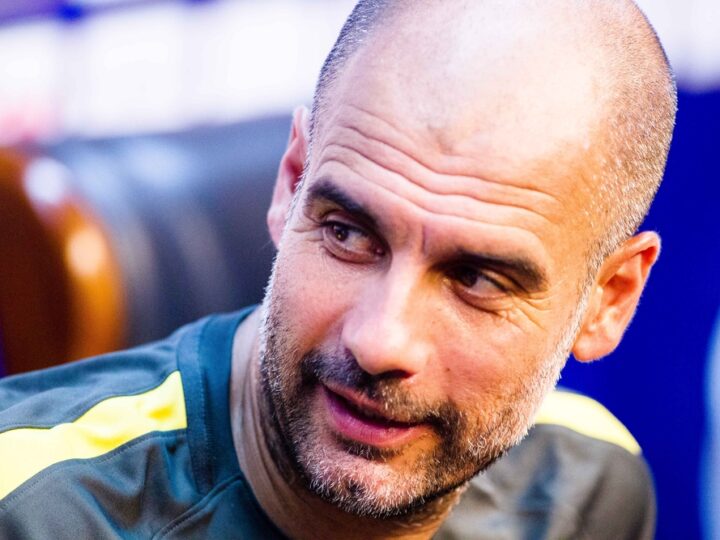 How many titles does Pep Guardiola have as coach??